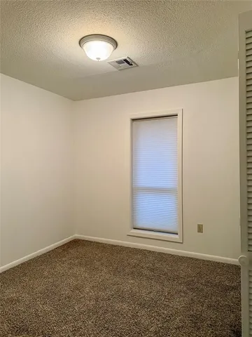 an empty room with a empty space and windows