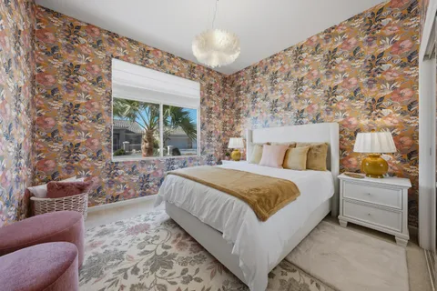 a bedroom with a bed and a chandelier