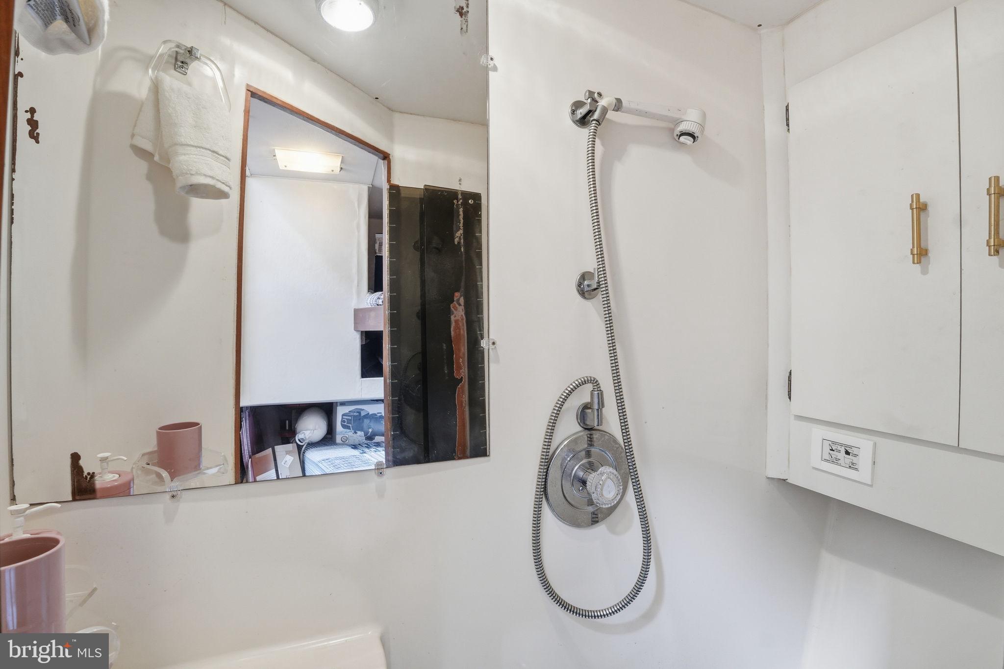 650 Wharf Street Southwest, Unit X48 Washington, DC 20024 - Photo 20 of 42 a bathroom with a granite countertop shower and a sink