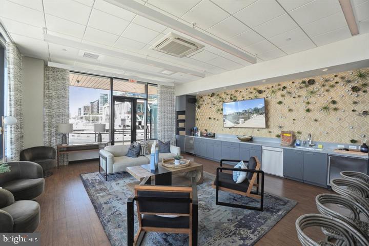 650 Wharf Street Southwest, Unit X48 Washington, DC 20024 - Photo 33 of 42 a dining room with furniture a large window and a rug