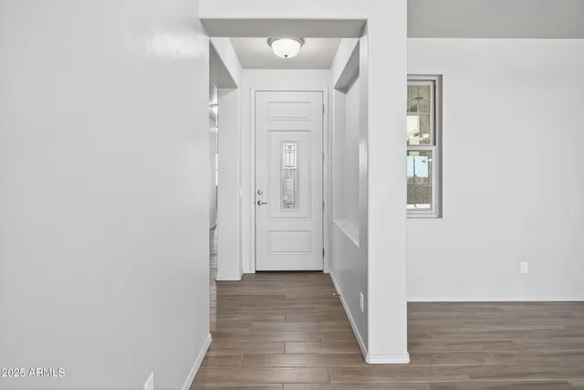 a view of a room with wooden floor and large windows