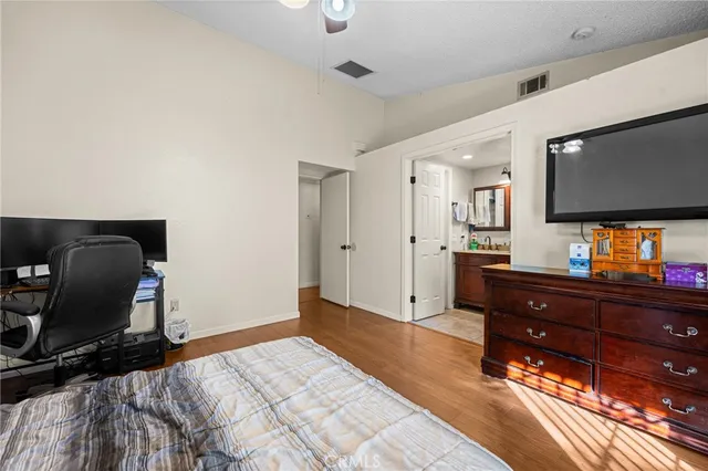 a bedroom with a bed and a flat screen tv