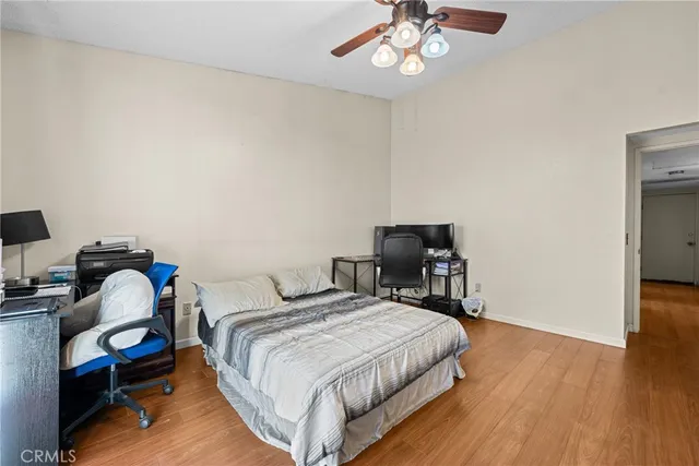 a bedroom with bed and a chandelier