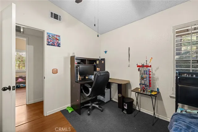 a view of a workspace with furniture and gym equipment