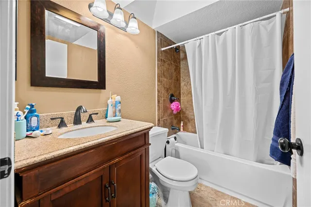 a bathroom with a sink vanity mirror and toilet