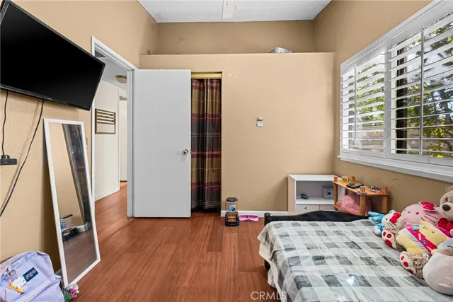 a bedroom with a bed and a window