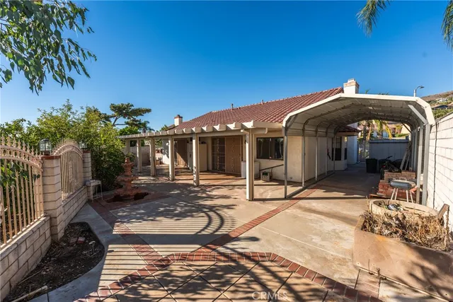 a view of a house with backyard porch and furniture