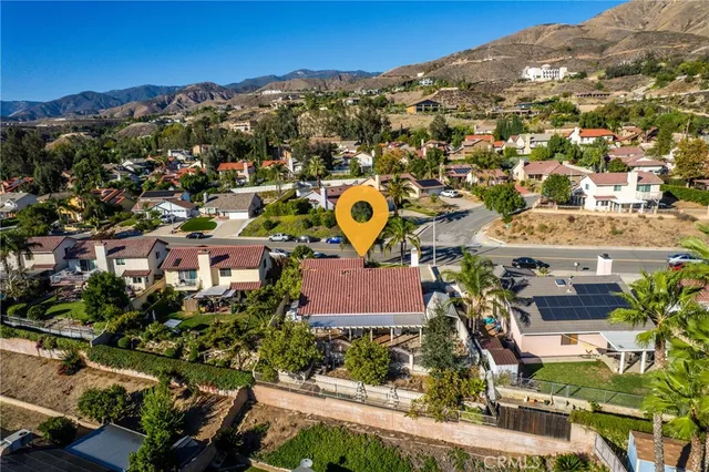 an aerial view of residential houses with outdoor space and parking