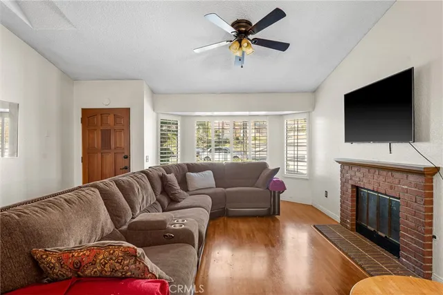 a living room with furniture fireplace and flat screen tv
