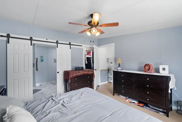 a bedroom with a bed and a dresser