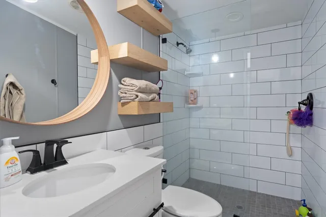 a bathroom with a sink toilet and shower