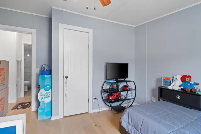 a bedroom with furniture and a flat screen tv