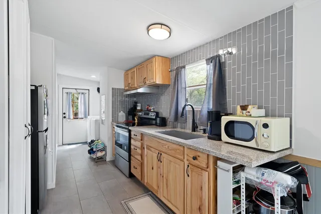 a kitchen with sink cabinets and refrigerator