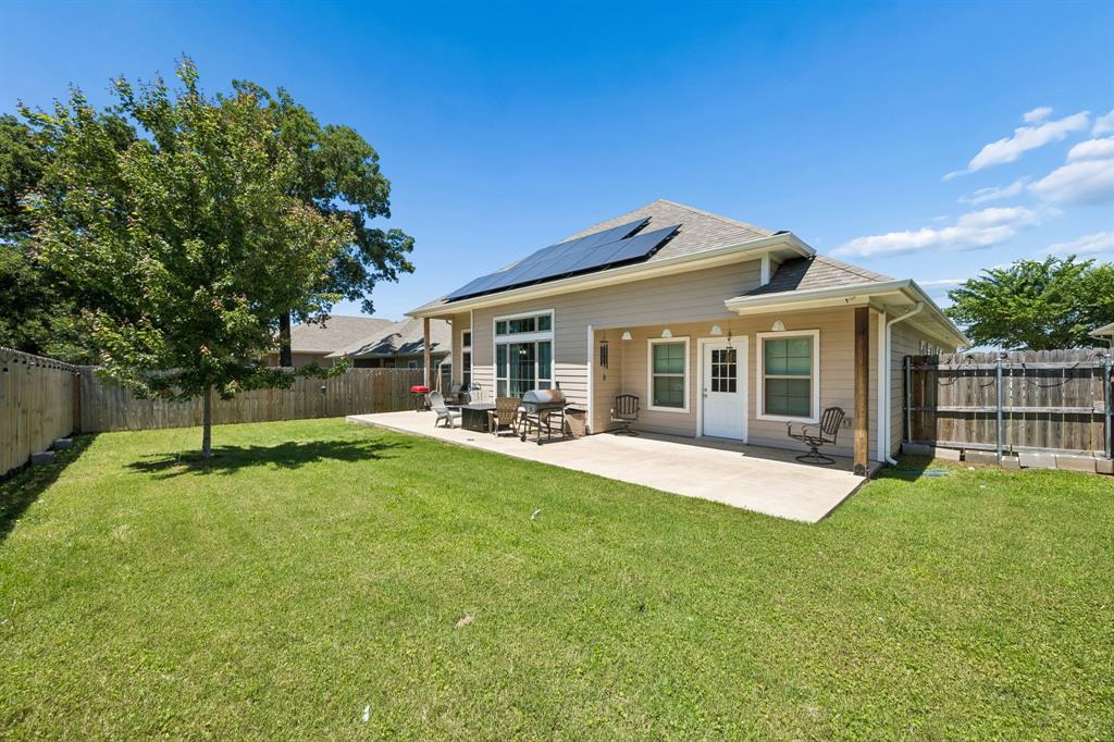 612 Frisco Road Sherman, TX 75090 - Photo 25 of 25 Expansive backyard featuring a manicured lawn, a large concrete patio, and a privacy fence