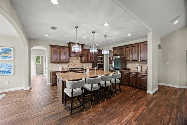 a large kitchen with a table and chairs