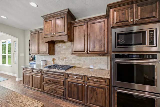 a bedroom with a bed and a flat tv screen on dresser