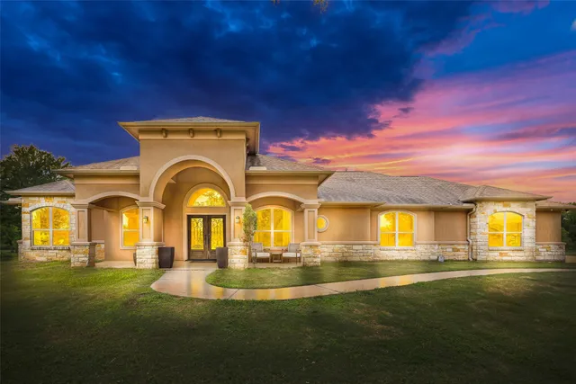 a front view of a house with a garden
