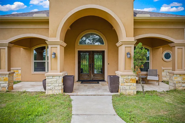 a view of a hallway with furniture and wooden floor
