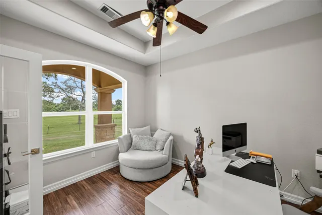 a living room with furniture and wooden floor
