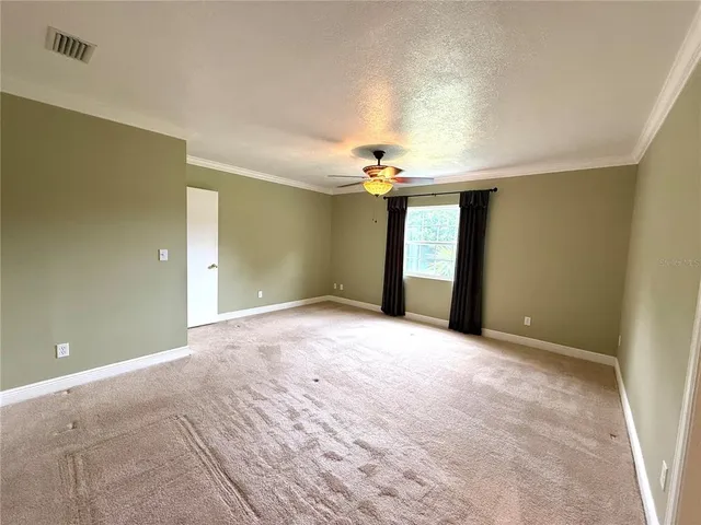 a view of an empty room with a chandelier