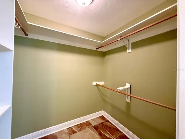 an empty room with a window and a ceiling fan