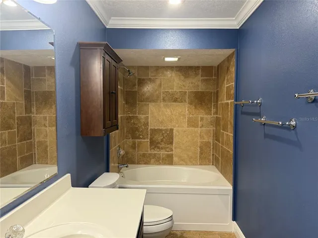 a bathroom with a toilet sink vanity and mirror