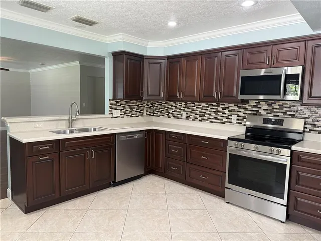 a kitchen with a sink stove and microwave