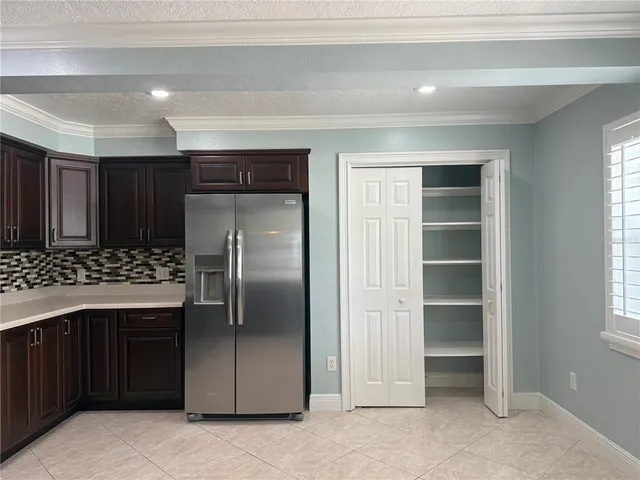 a kitchen with a refrigerator and a sink