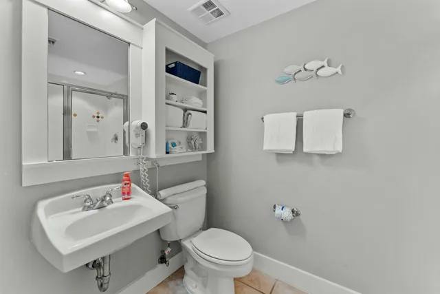 a bathroom with a sink toilet and mirror