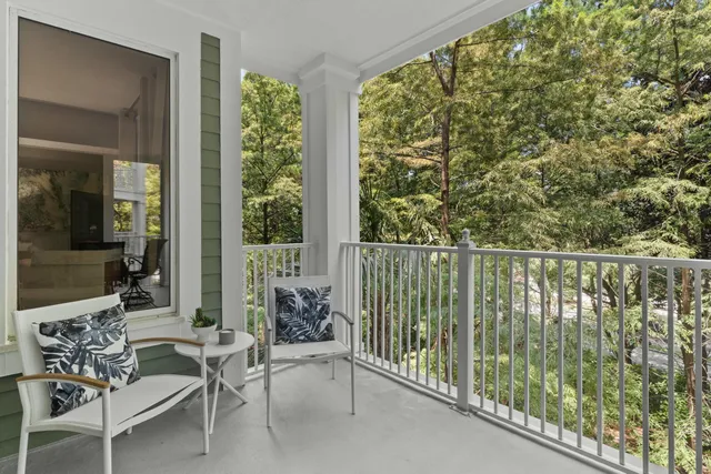 a balcony with chairs and with wooden floor