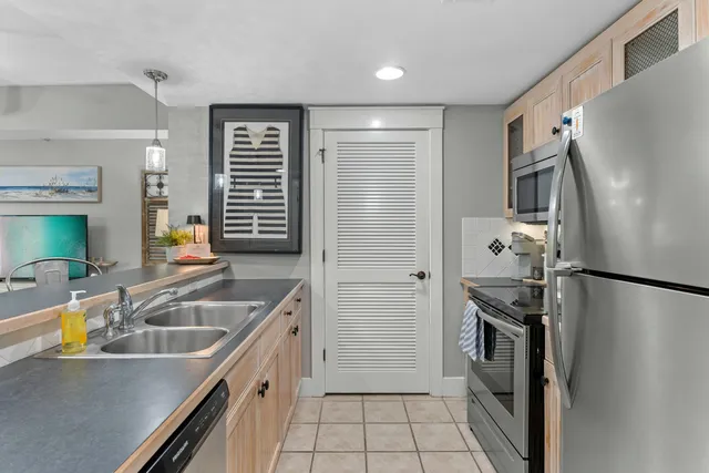 a kitchen that has a sink cabinets counter space and stainless steel appliances