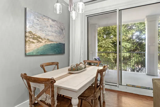 a view of a dining room with furniture wooden floor and a chandelier