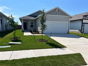 View of front of home with an attached garage, a front yard, driveway, board and batten siding, and covered porch