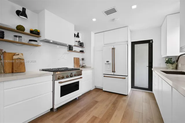 a kitchen with cabinets and stainless steel appliances