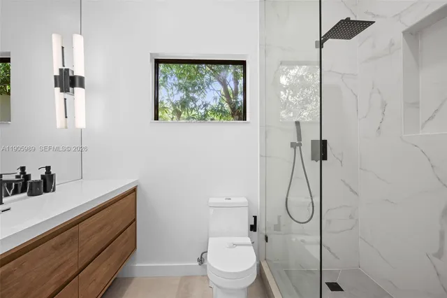 a bathroom with a toilet sink and shower