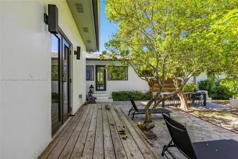 a view of a house with backyard and sitting area