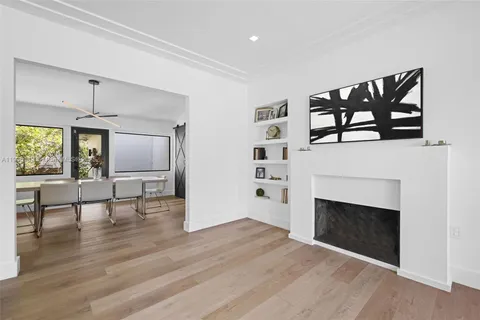 a view of empty room with wooden floor and fireplace