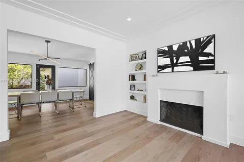 a view of empty room with wooden floor and fireplace