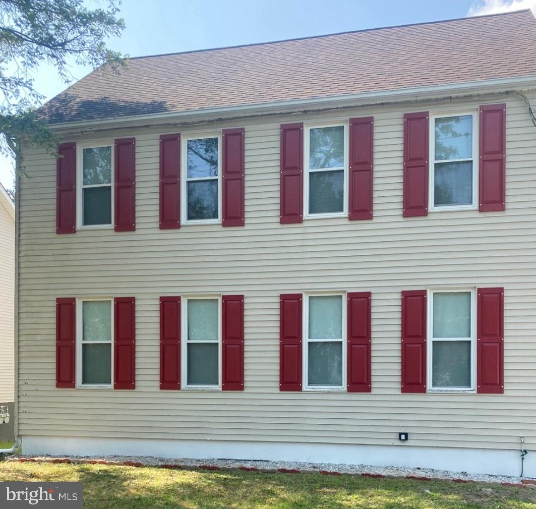 a view of a brick house with many windows