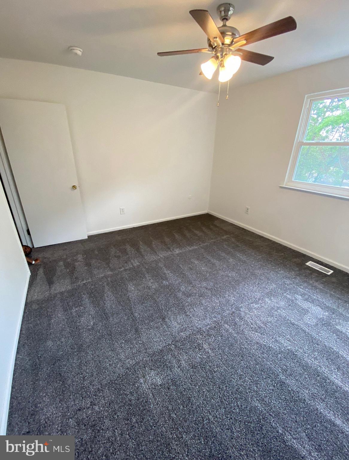 615 B Jarvis Road Sicklerville, NJ 08081 - Photo 5 of 5 an empty room with a window and a fan