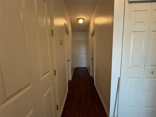 a bathroom with a granite countertop sink a toilet a mirror and shower