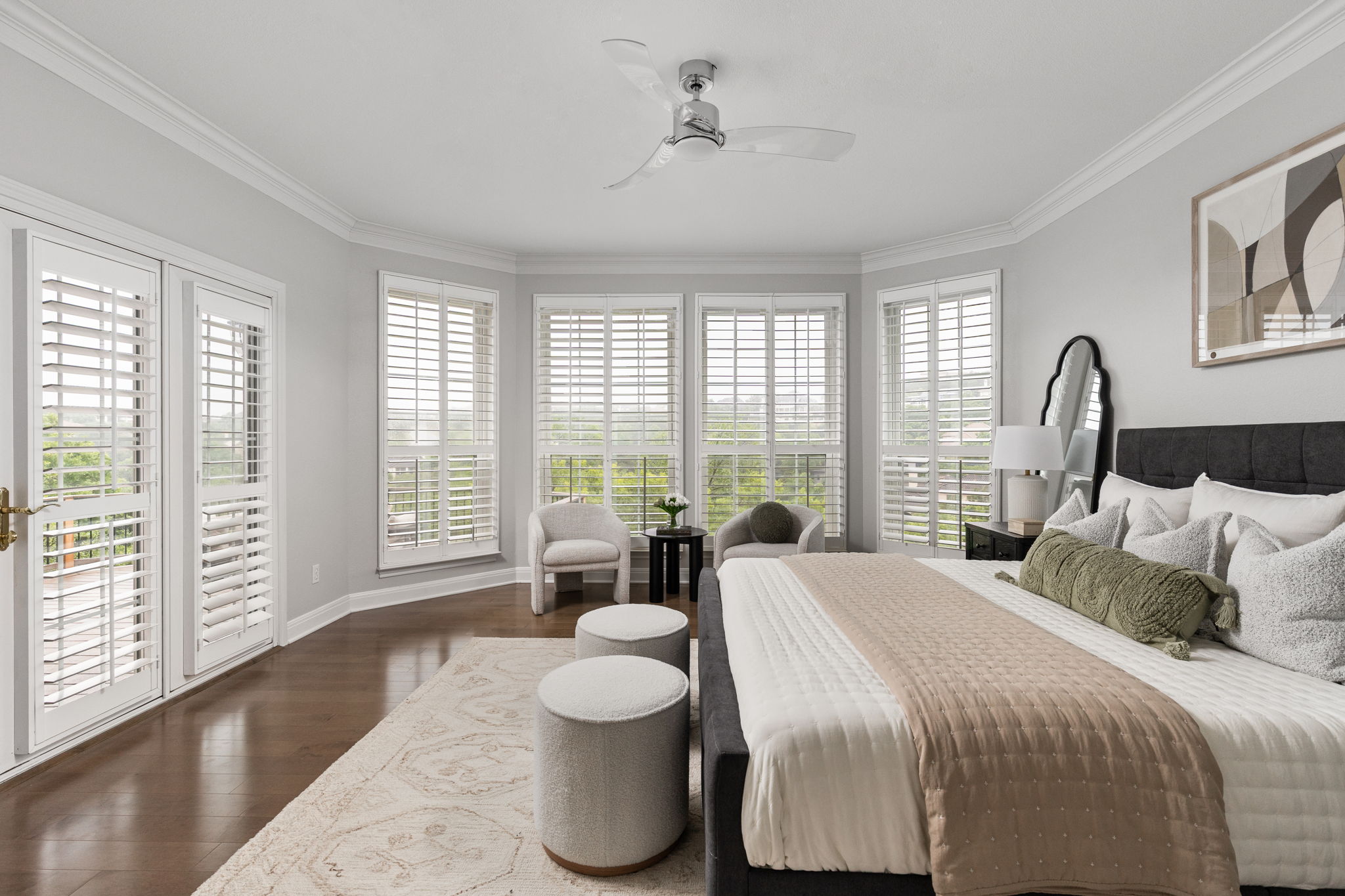 2807 Round Table Road Austin, TX 78746 - Photo 14 of 40 Spacious bedroom featuring rich wood-finish flooring, a contemporary ceiling fan, and extensive crown molding