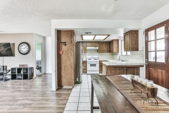 604 South Lakeview Court Ridgecrest, CA 93555 - Photo 6 of 29 a open kitchen with stainless steel appliances granite countertop a stove and cabinets