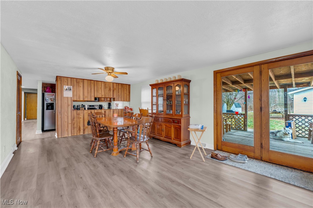 14808 Darrow Road Vermilion, OH 44089 - Photo 18 of 45 Dining space featuring ceiling fan, a textured ceiling, and light wood-type flooring