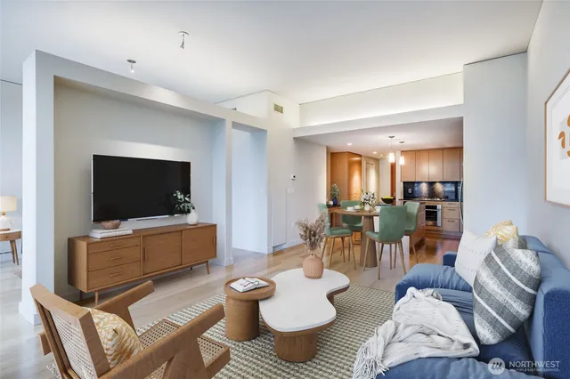 a kitchen with granite countertop a table chairs stove and wooden floor