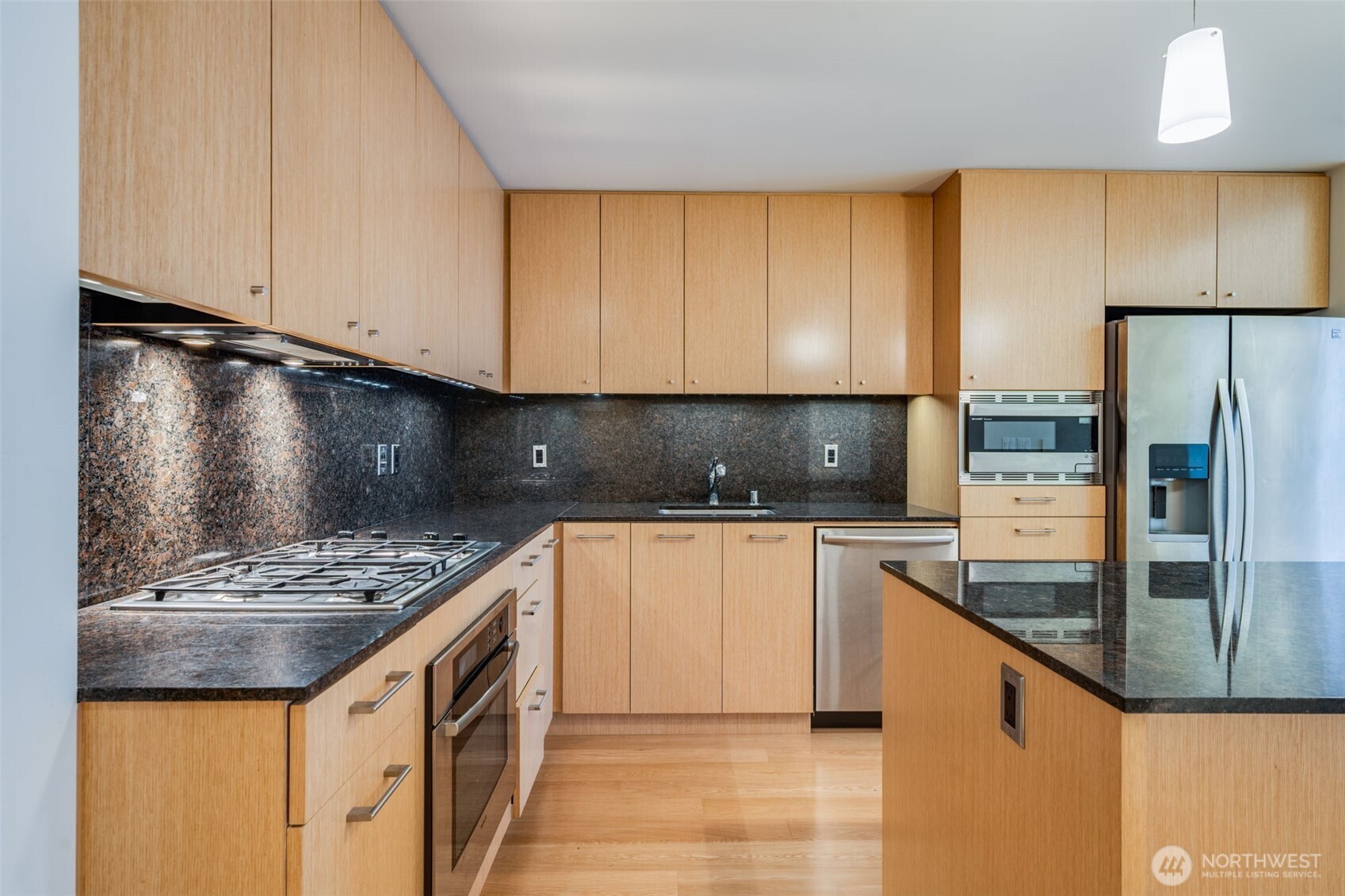 909 5th Avenue, Unit 1203 Seattle, WA 98164 - Photo 14 of 32 a kitchen with stainless steel appliances granite countertop a sink stove and refrigerator