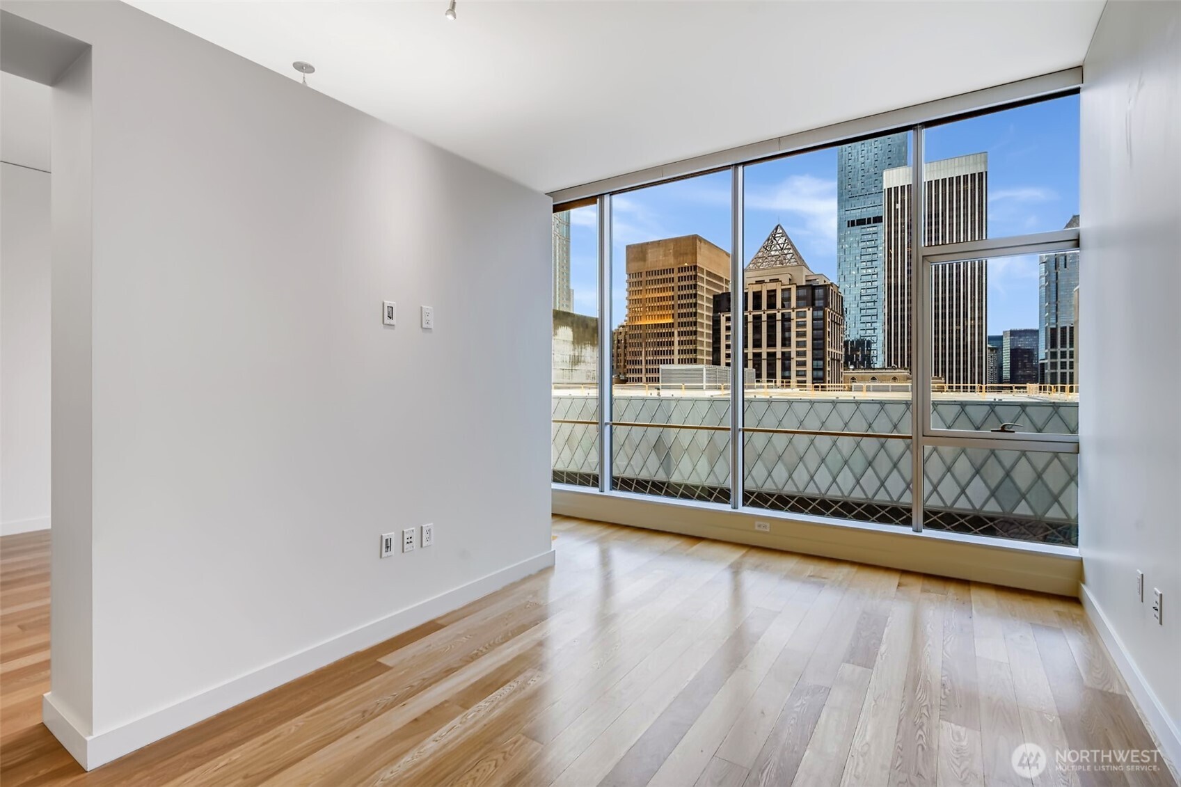 909 5th Avenue, Unit 1203 Seattle, WA 98164 - Photo 16 of 32 a view of an empty room with wooden floor and a window