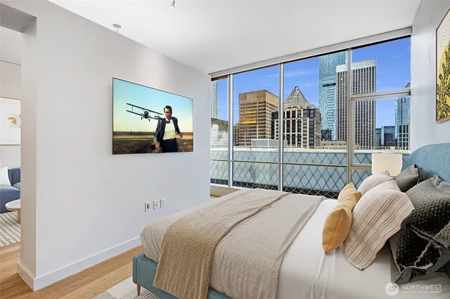 a view of a hallway with wooden floor and a bathroom