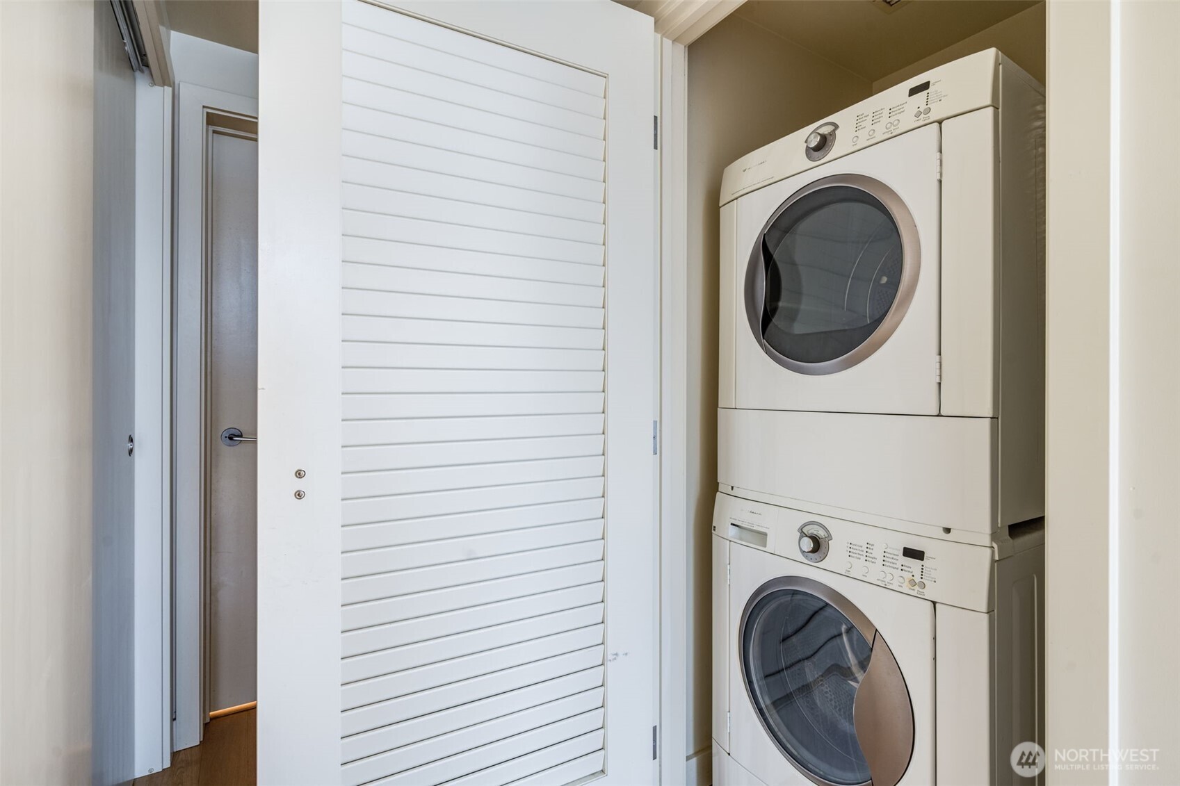 909 5th Avenue, Unit 1203 Seattle, WA 98164 - Photo 25 of 32 a view of a hallway with washer and dryer