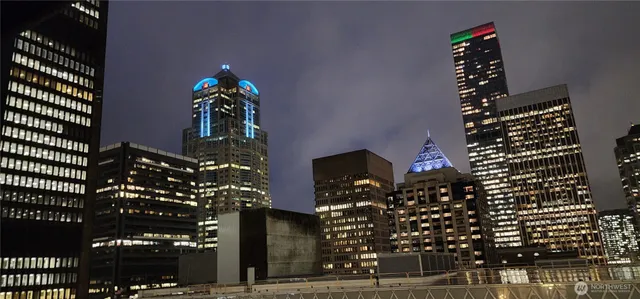 a view of a hallway with wooden floor and a kitchen